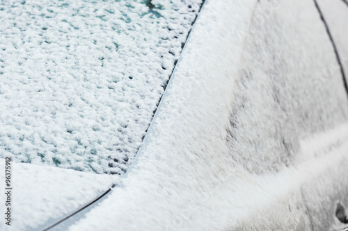 Closeup of a car covered in snow and ice photo