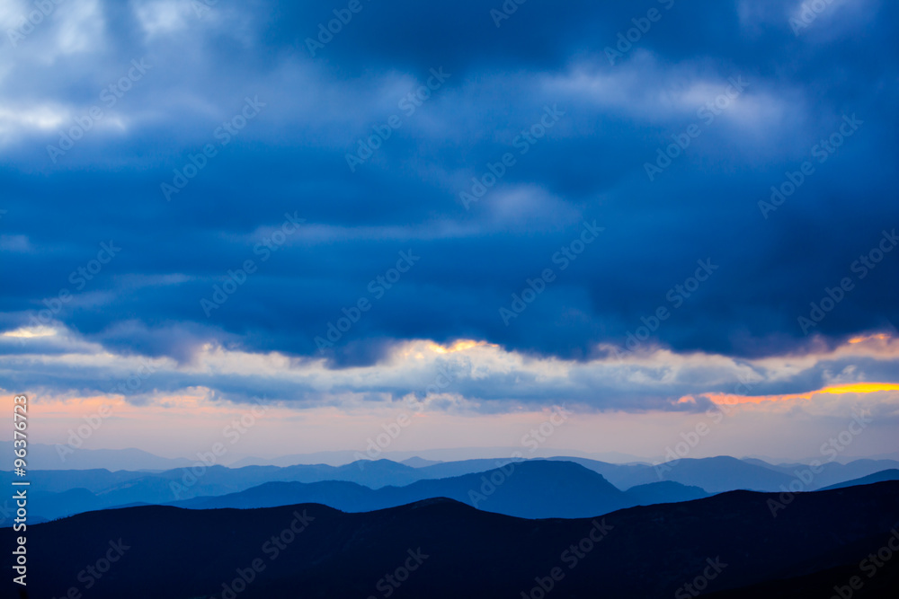 Layered peaks with dramatic clouds landscape