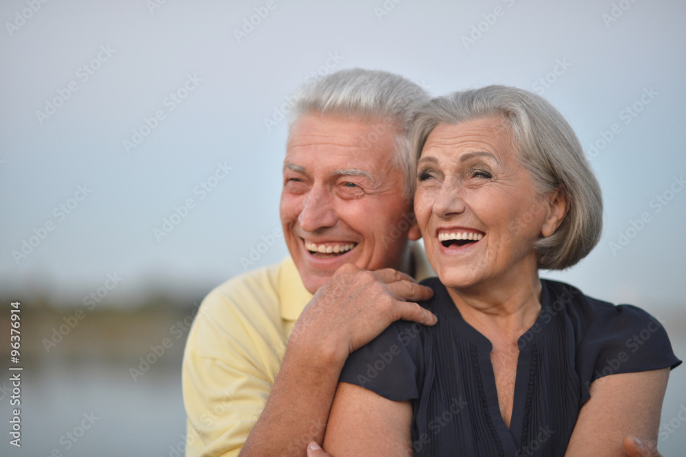 Happy senior couple  near river