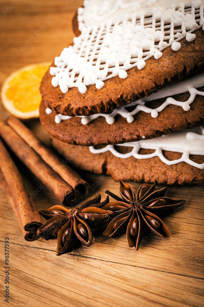 Fototapeta premium Close up heart shape gingerbread cookies with spices on rustic table