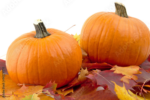 Decoration of pumpkins with autumn leaves for thanksgiving day on white