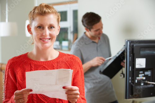 Happy Customer With Bill For TV Installation