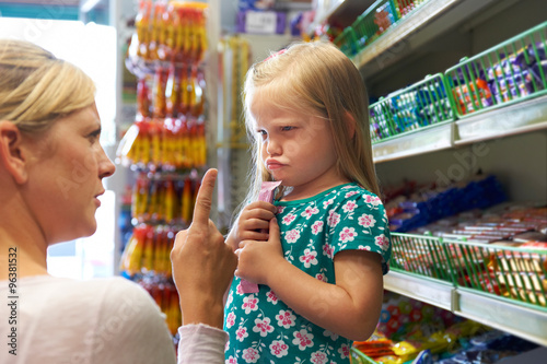 Child Having Arguement With Mother At Candy Counter photo