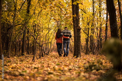 Young couple walking in the autumn park