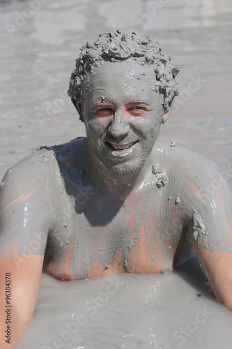 Portrait happy man who takes a mud bath. Dalyan, Turkey
