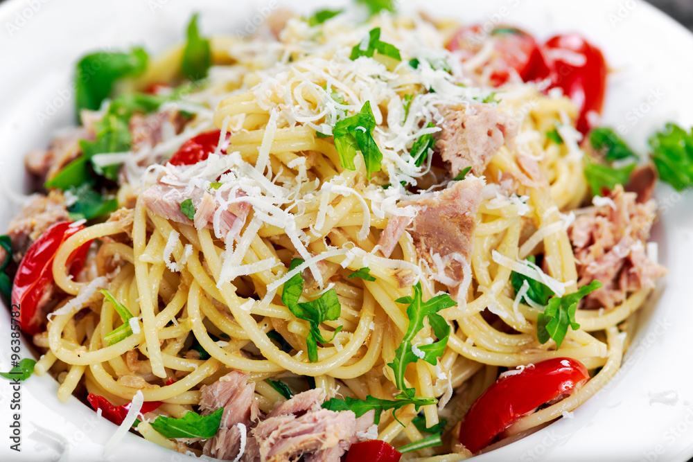 Close up Italian Tuna Pasta spaghetti with tomato, chilli, parmesan and wild rocket lives. Close up Italian Tuna Pasta spaghetti with tomato, chilli, parmesan and wild rocket lives.