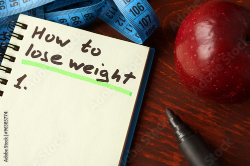 Notebook with  how to lose weight sign. Diet concept.
