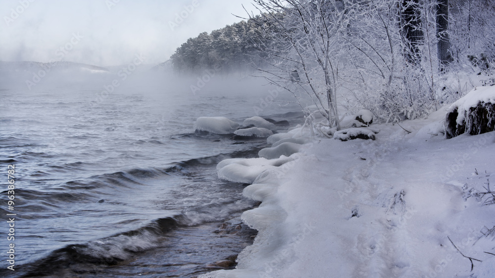Winter Russian lake - water, mist, snow forest and mountains Winter Russian lake - water, mist, snow forest and mountains