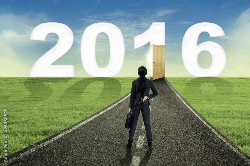 Woman looking at number 2016 on the street Woman looking at number 2016 on the street