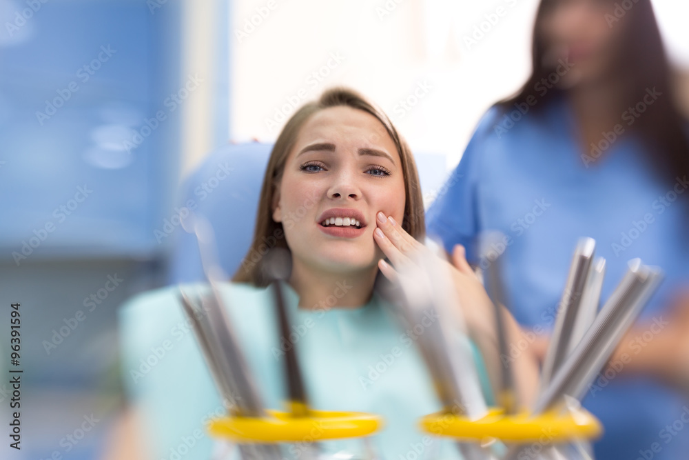 Girl in dental ambulance hold sore spot Girl in dental ambulance hold sore spot