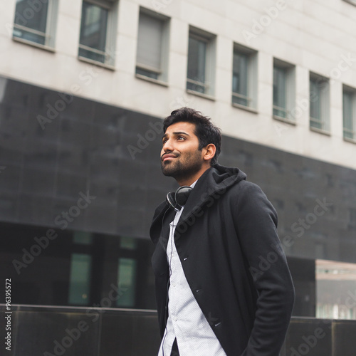 Handsome Indian man posing in an urban context