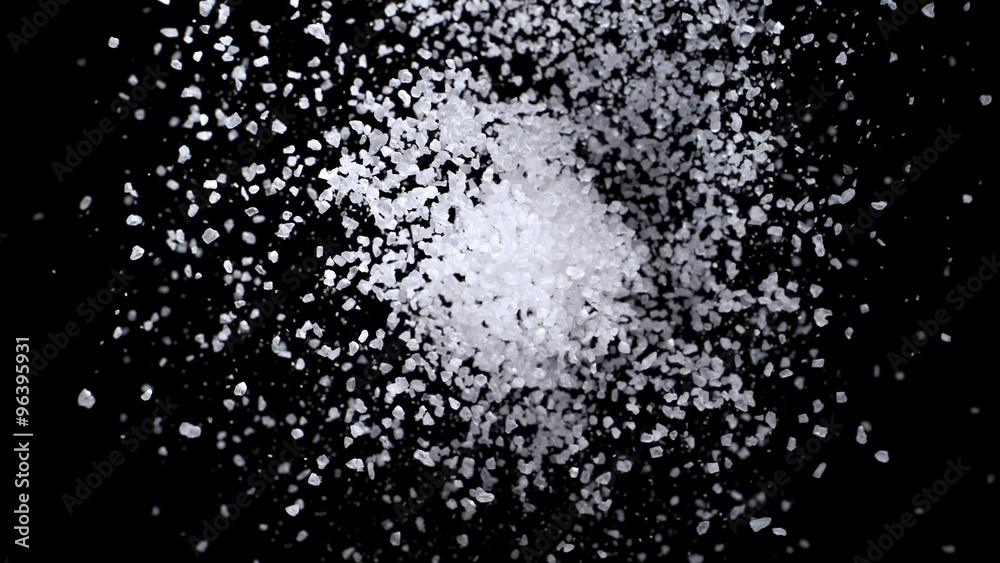 Salt Exploding Sea salt exploding against black background. Shot with high speed ...