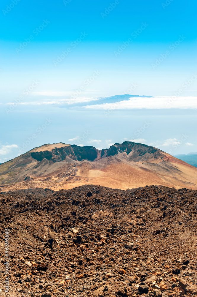Crater of Pico Viejo volcano on a blue cloudscape background