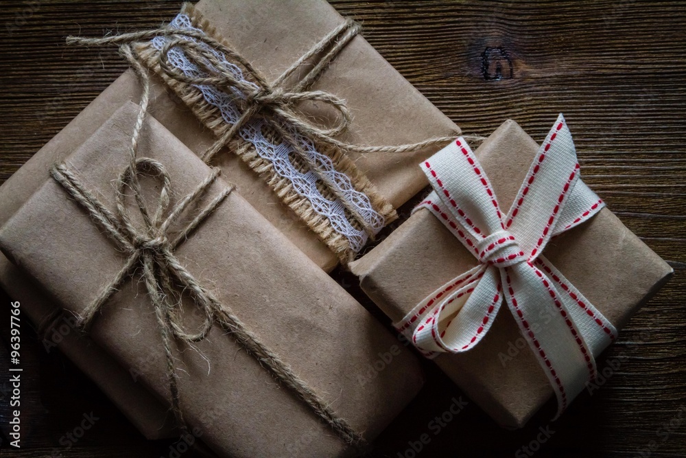Presents in rustic wrap, wood background Presents in rustic wrap, wood background