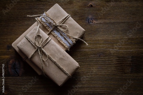Presents in rustic wrap, wood background