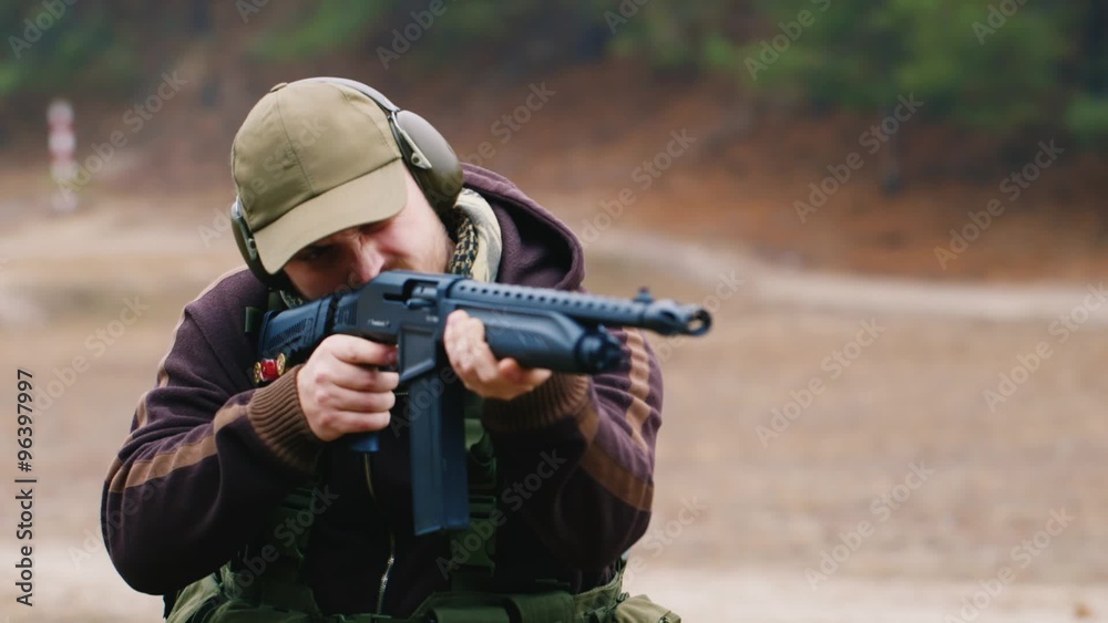 Man shooting a shotgun Man shooting a shotgun