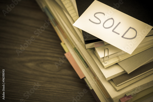 Sold; The Pile of Business Documents on the Desk photo