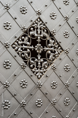 old iron door with with beautiful grille and decorative pattern