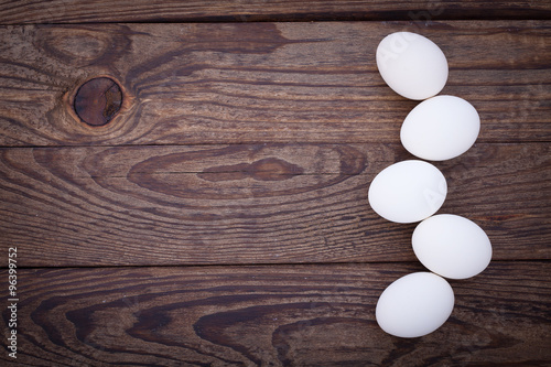 eggs on wooden background top view