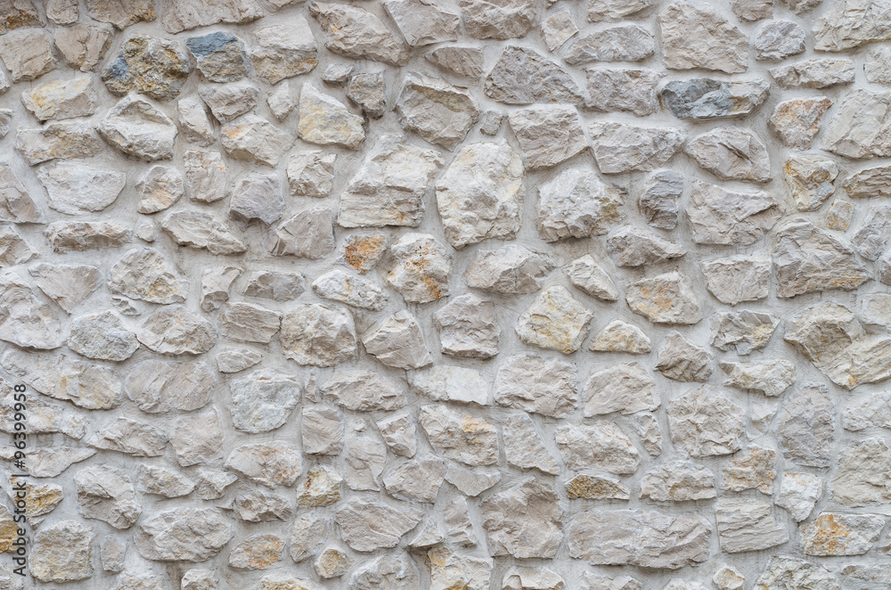 Old wall made of small irregular limestone stones Old wall made of small irregular limestone stones