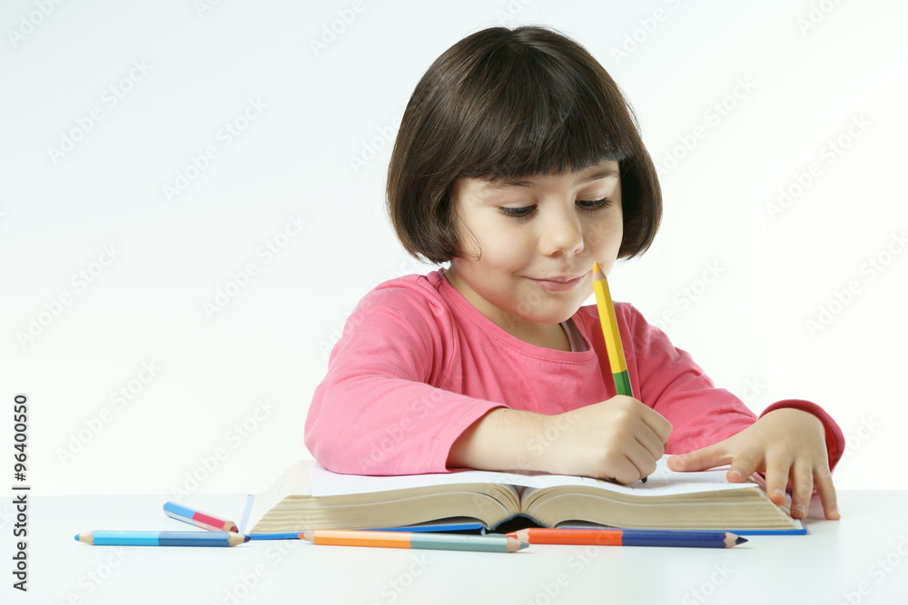 little girl is doing homework on a white background, dressing a pink shirt
little girl is doing homework on a white background, dressing a pink shirt