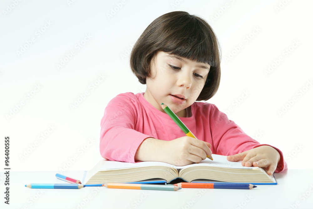 little girl is doing homework on a white background, dressing a pink shirt
little girl is doing homework on a white background, dressing a pink shirt