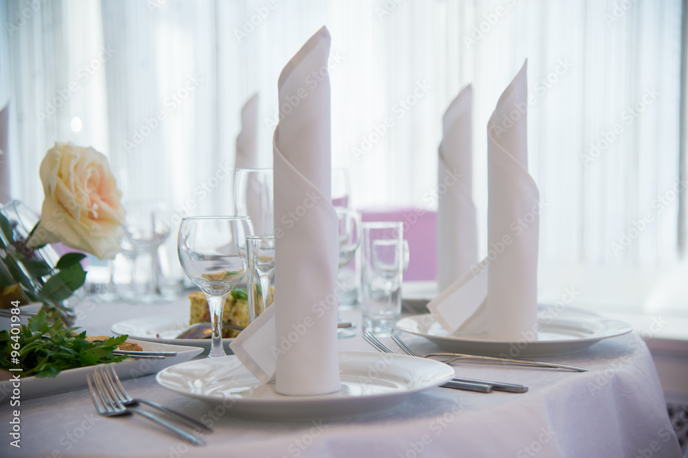 Serving festive table with plates and forks. Linen napkins on the table. Festive food. Serving of food. Cold snacks. Dish of food. Menu for a person. Food for anniversaries, weddings and celebrations. Serving festive table with plates and forks. Linen napkins on the table. Festive food. Serving of food. Cold snacks. Dish of food. Menu for a person. Food for anniversaries, weddings and celebrations.