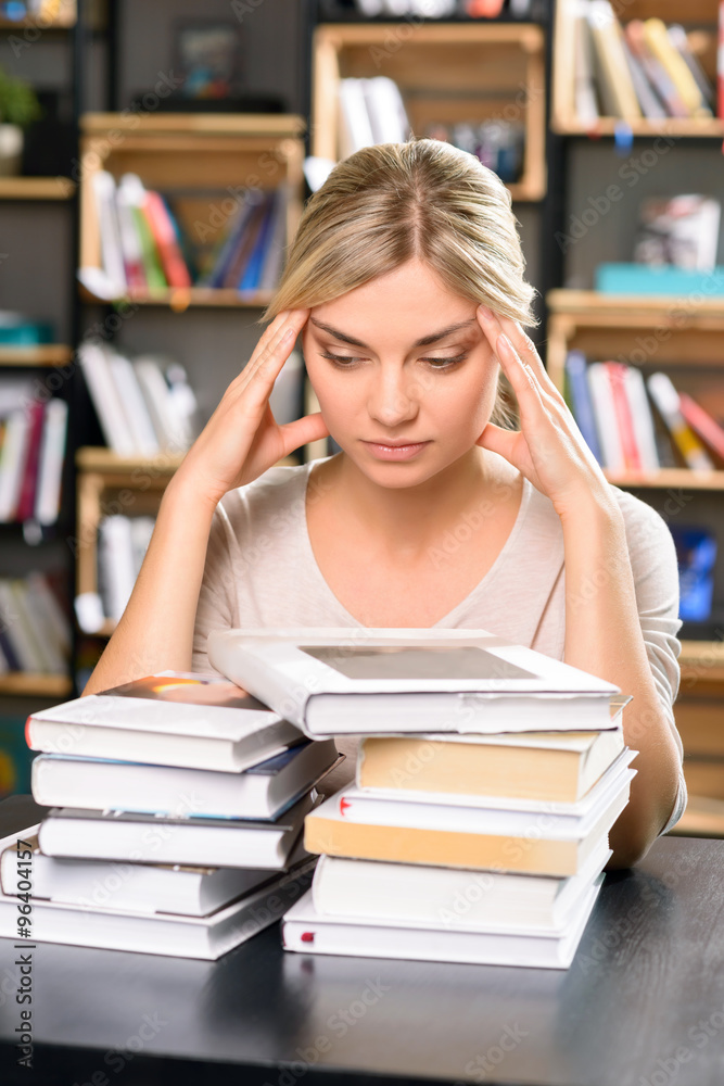 Young lady at the library looks thoroughly tired. Young lady at the library looks thoroughly tired.
