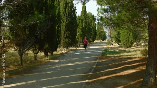 Wallpaper Mural Young woman running in the park at the alley. She running at camera Torontodigital.ca