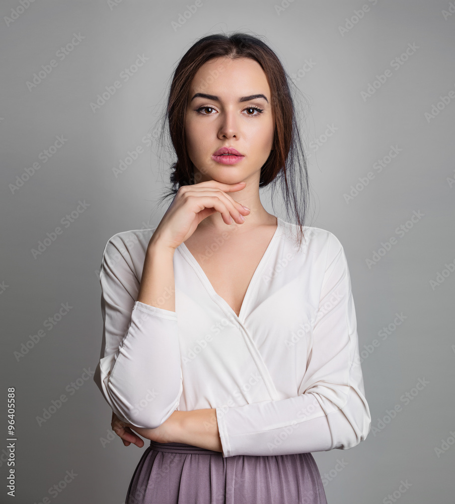 Beautiful young woman against gray background Beautiful young woman against gray background
