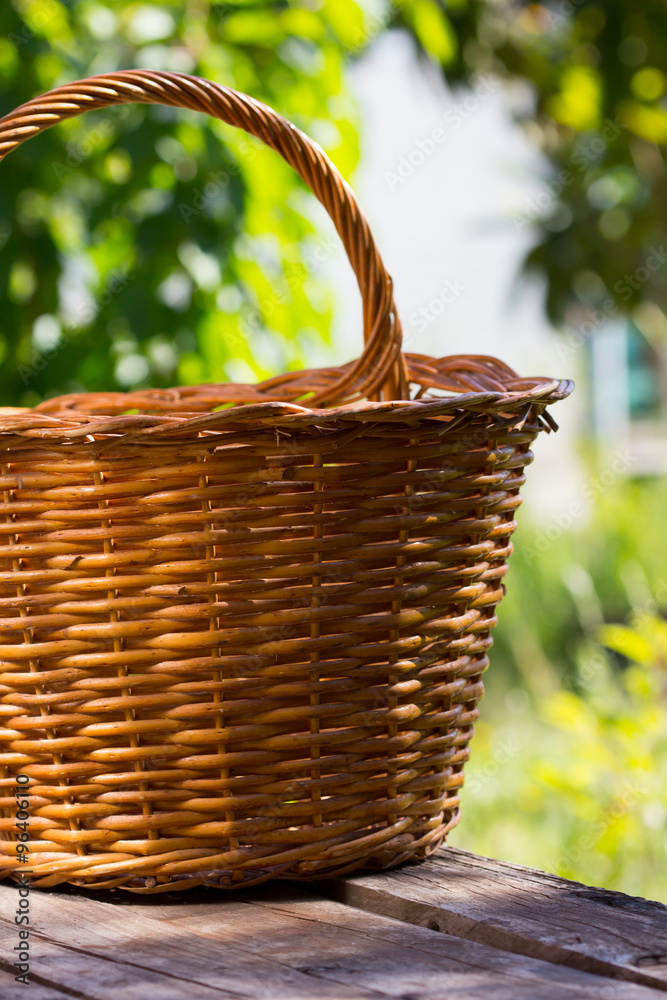 basket on old wooden table in garden basket on old wooden table in garden