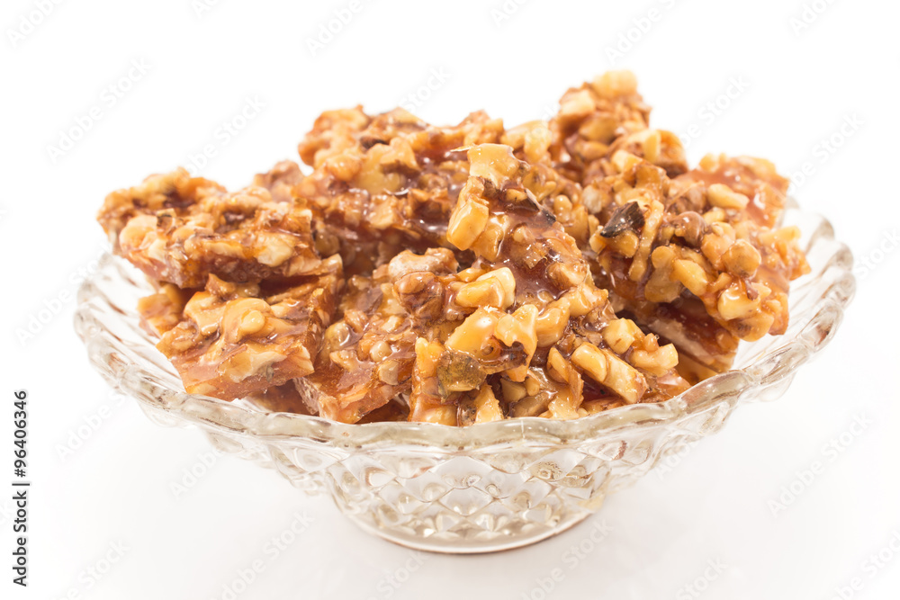 Homemade candies with walnuts in a glass bowl Homemade candies with walnuts in a glass bowl