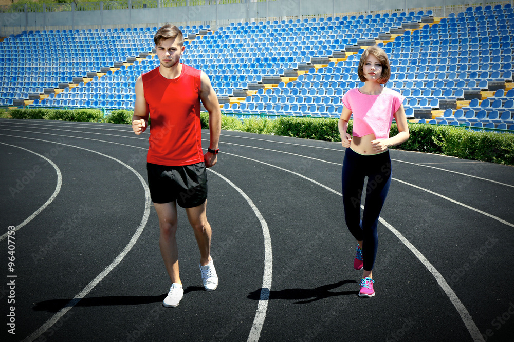 Obraz premium Young people jogging on stadium