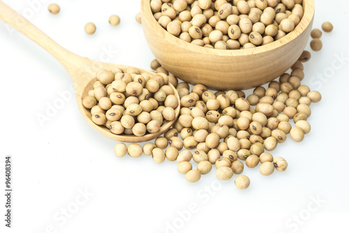 Soy beans in spoon isolated on white background