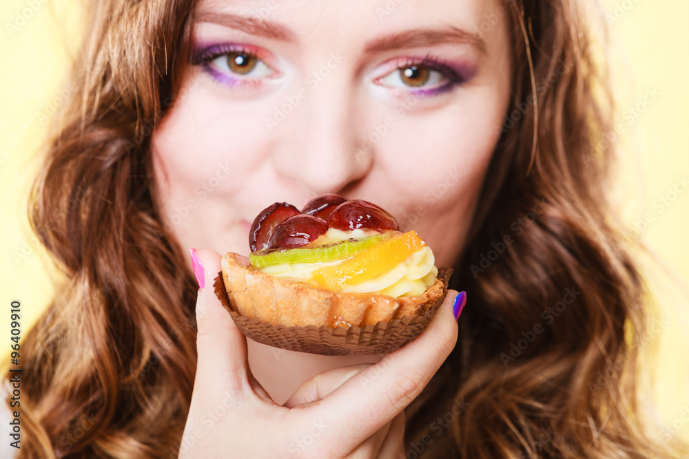 Closeup woman face and fruit cake Closeup woman face and fruit cake