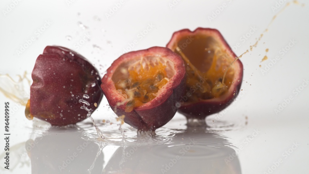 Passion fruit falling and bouncing on water surface. Shot with high speed camera, phantom flex 4K.  Slow Motion. 