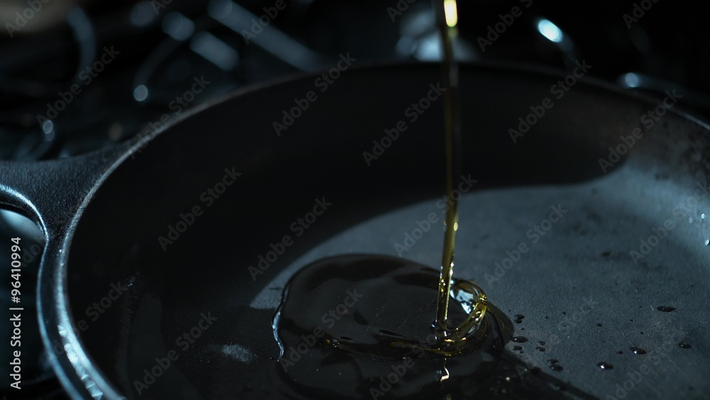 Pouring oil over fry pan. Shot with high speed camera, phantom flex 4K. Slow Motion.