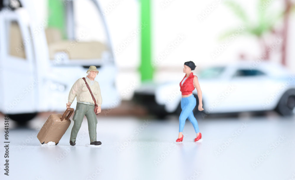 Miniature people at a bus station