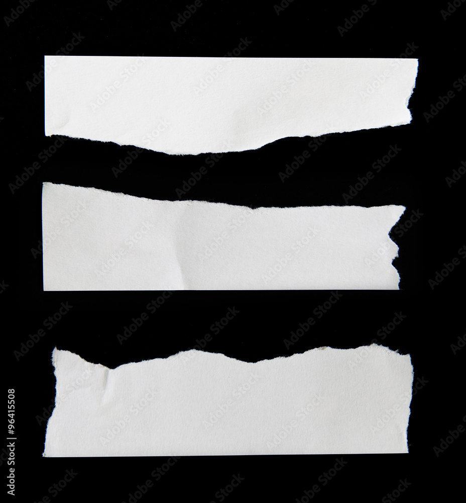 Fototapeta premium Piece of torn paper on black. Copy space