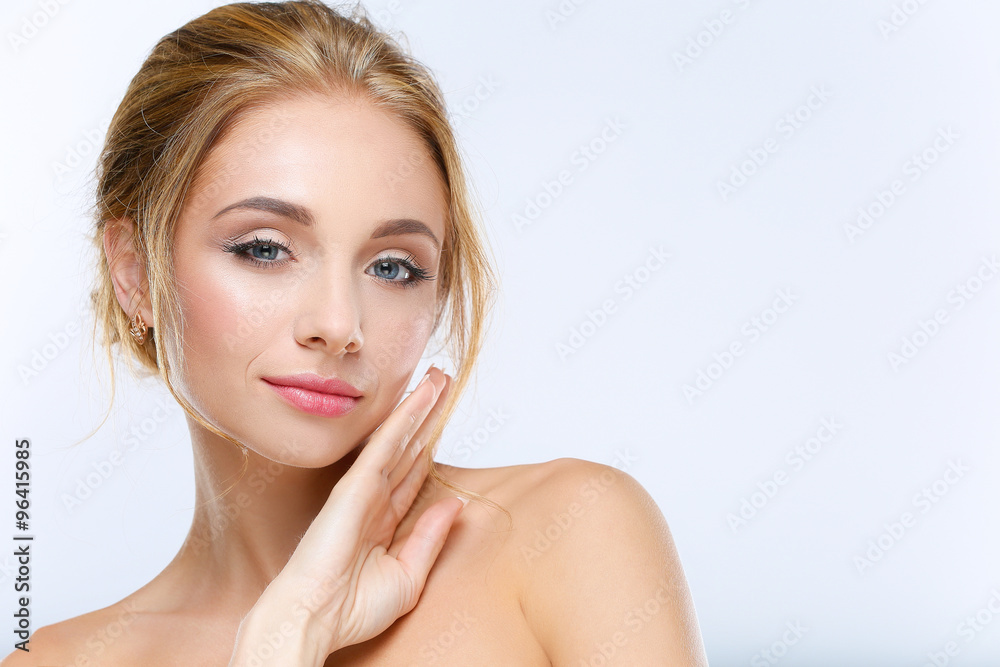 Young woman touching her face isolated on white background Young woman touching her face isolated on white background