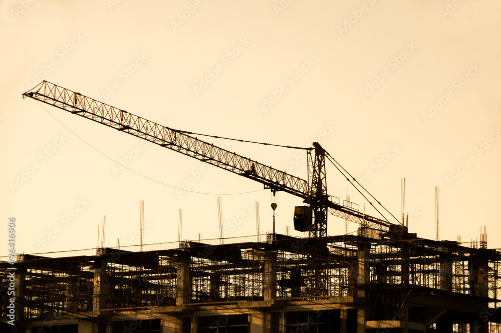 Iron crane in construction Site silhouettes