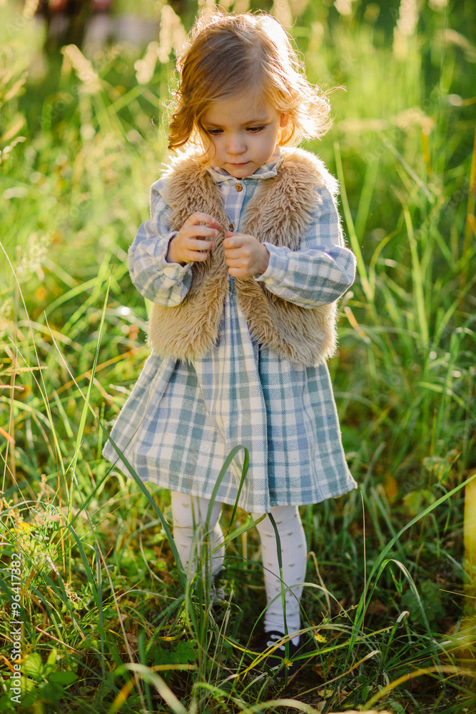 Cute smiling girl in a green field in sunset Cute smiling girl in a green field in sunset