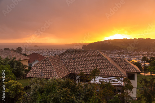 Houses and yahts during rainy sunset 