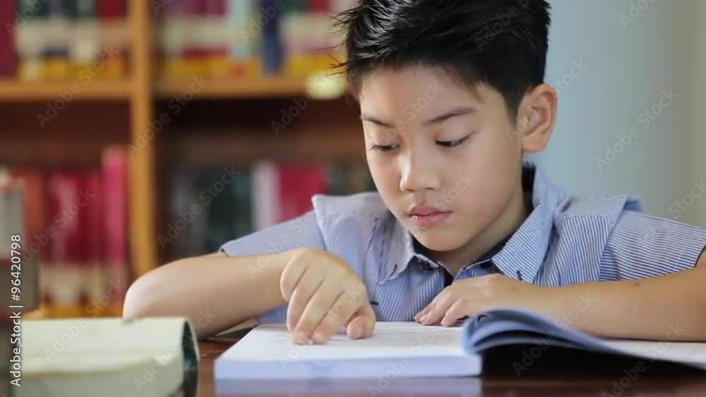 little asian boy bee bored with reading,library in thailand little asian boy bee bored with reading,library in thailand