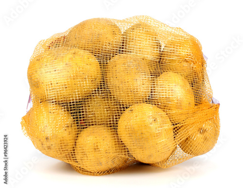 Heap of yellow raw potatos in red string bag