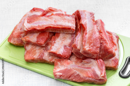 Raw pork ribs on a cutting board. Step on step recipe.