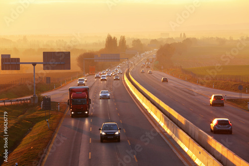 Fototapeta Naklejka Na Ścianę i Meble -  Highway Traffic at Sunset.