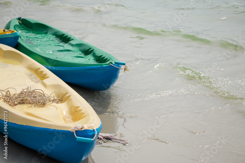 Canoe, kayaks land on the beach at beach of Toey Ngam, Thailand. photo