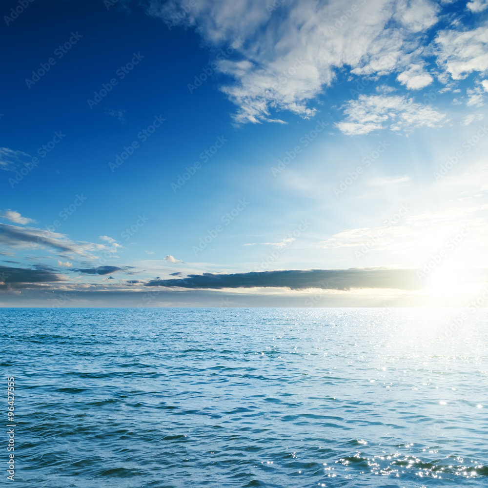 Obraz premium sunset over blue sea