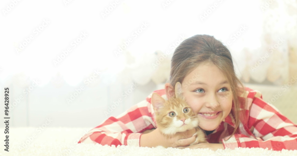 ginger kitten and child lying on a fluffy carpet ginger kitten and child lying on a fluffy carpet